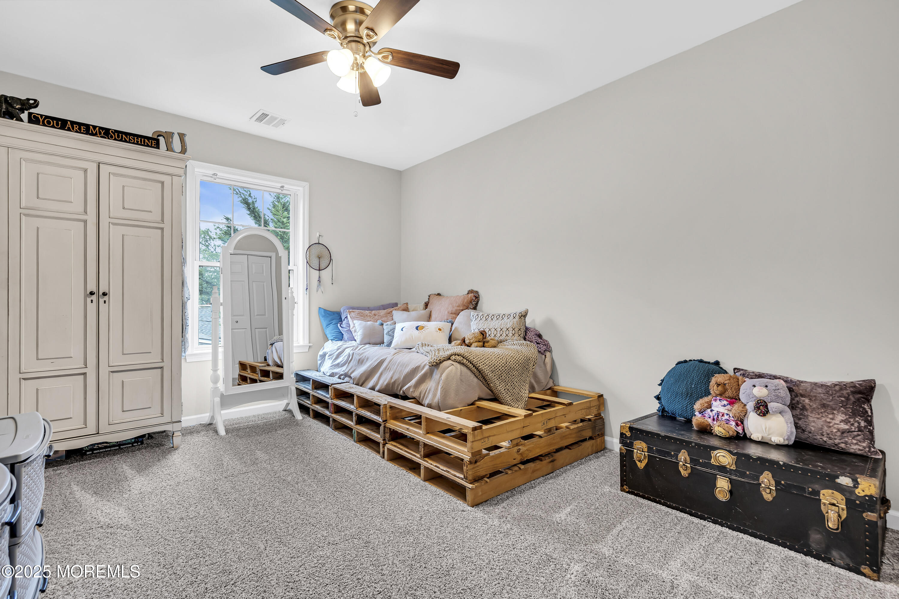 167 Captain Road Manahawkin, NJ 08050 - Photo 61 of 86 a bedroom with furniture and a chandelier fan