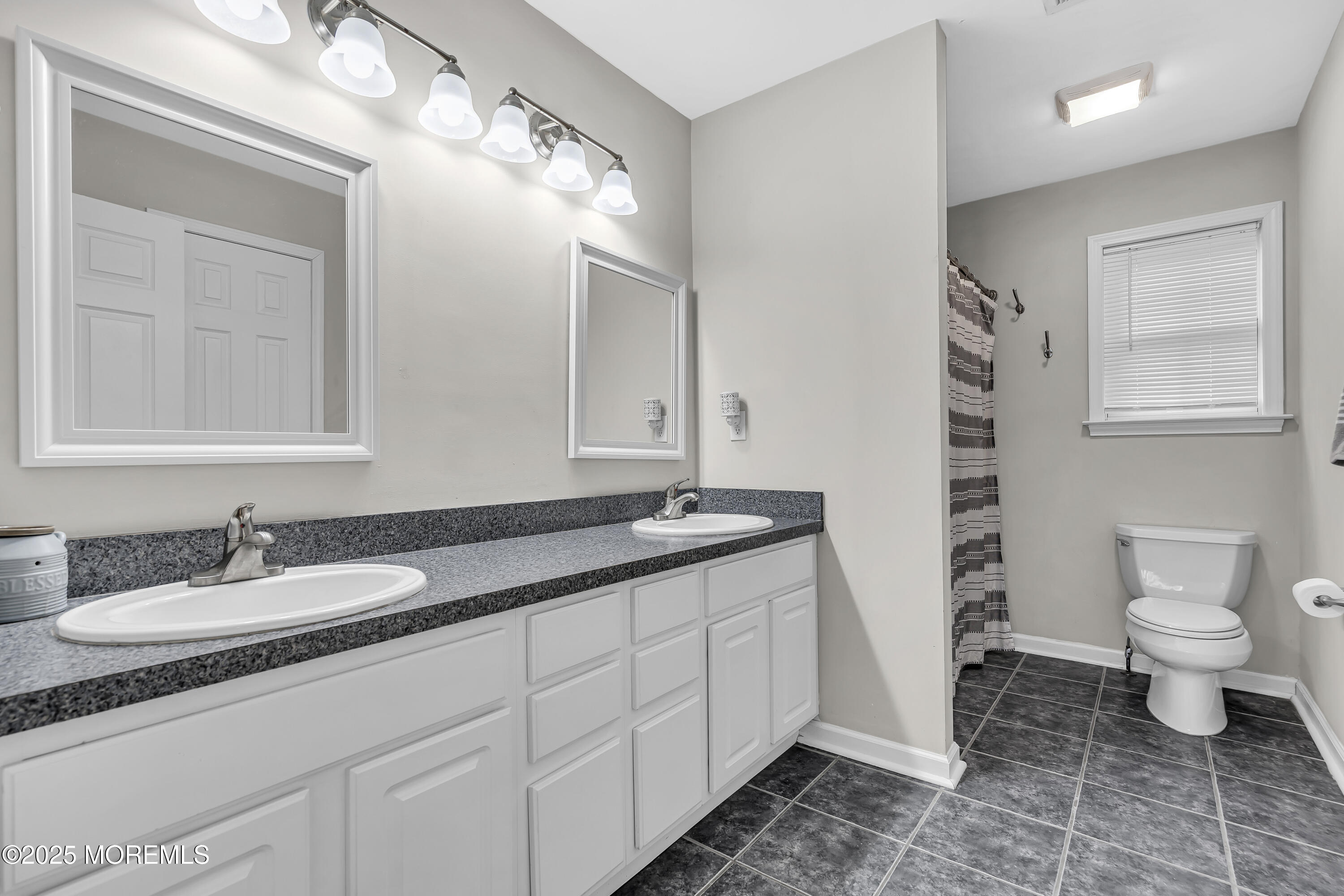 167 Captain Road Manahawkin, NJ 08050 - Photo 63 of 86 a bathroom with a granite countertop sink a toilet and a mirror
