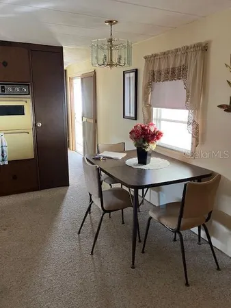 a dining room with furniture and window