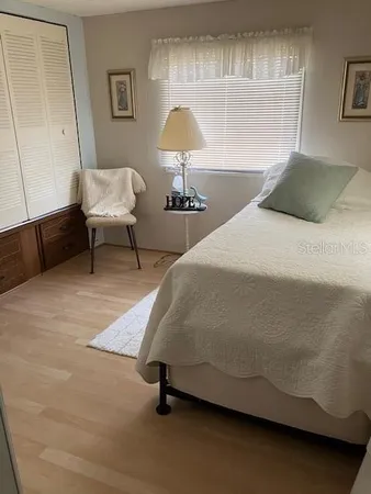 a bedroom with a bed and a lamp
