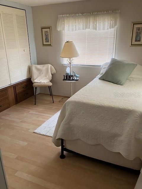 3405 Lanark Drive Holiday, FL 34690 - Photo 17 of 32 a bedroom with a bed and a lamp