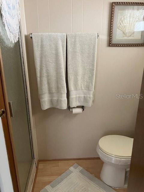 3405 Lanark Drive Holiday, FL 34690 - Photo 19 of 32 a white toilet sitting next to a shower curtain