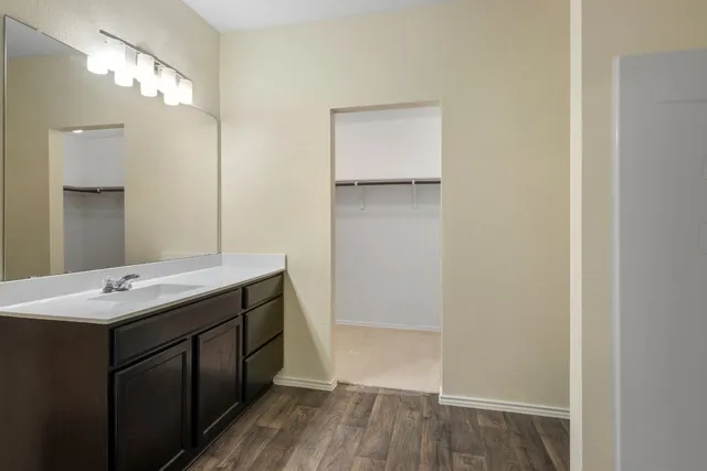 a view of a house with a yard and a large tree