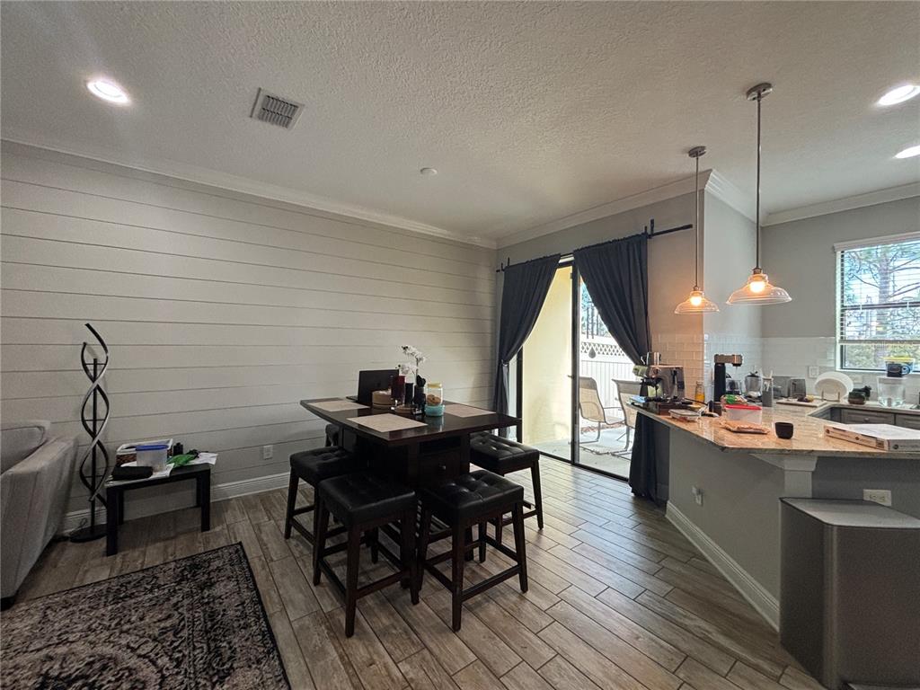 9136 Fox Sparrow Road Tampa, FL 33626 - Photo 11 of 34 a kitchen island with a table and chairs in it