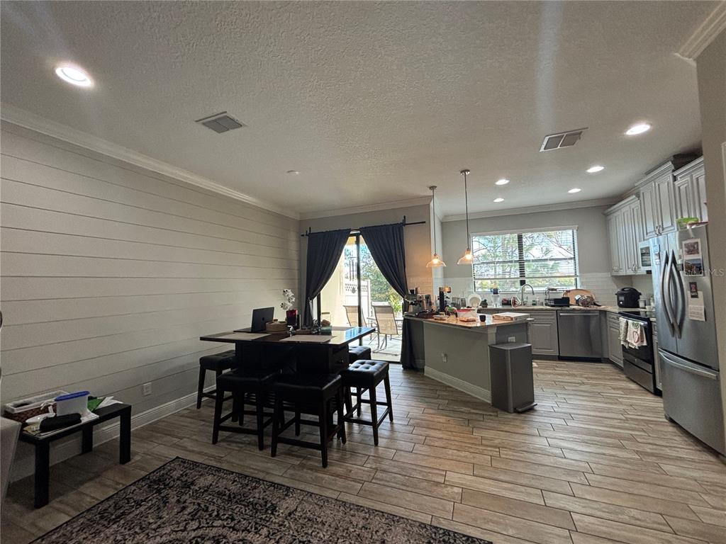 9136 Fox Sparrow Road Tampa, FL 33626 - Photo 12 of 34 a view of a dining room with furniture window and wooden floor