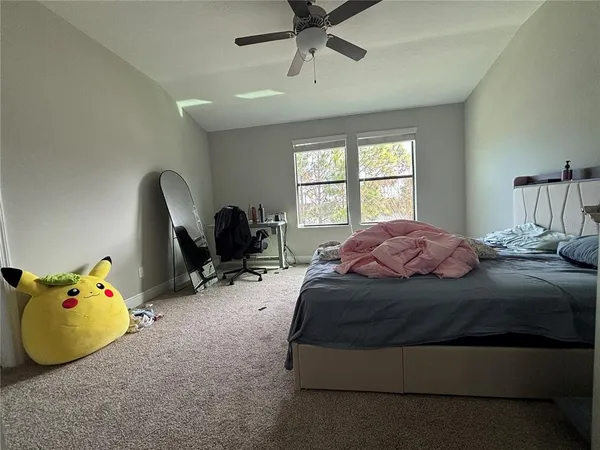 a bed room with a bed and a chair