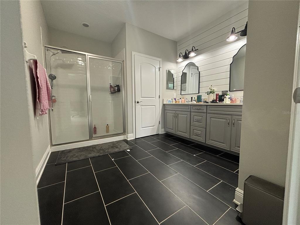 9136 Fox Sparrow Road Tampa, FL 33626 - Photo 19 of 34 a bathroom with a double vanity sink mirror and shower