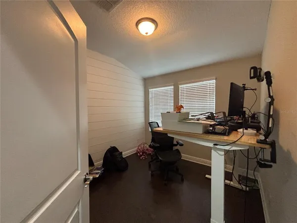 a view of a workspace with furniture and a window