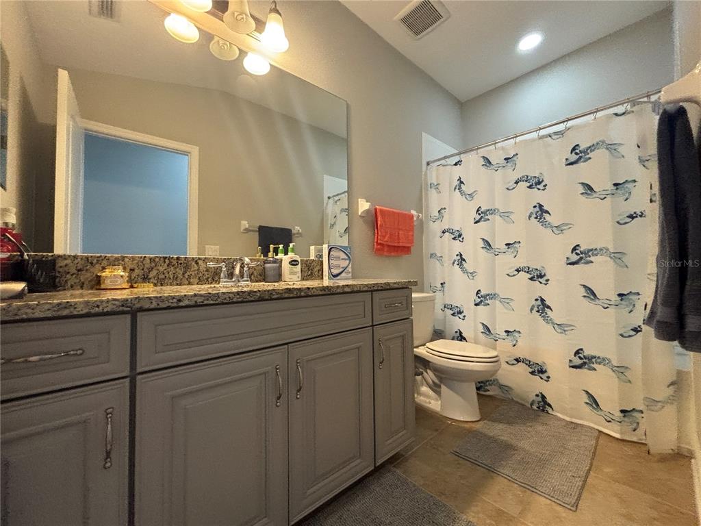 9136 Fox Sparrow Road Tampa, FL 33626 - Photo 27 of 34 a bathroom with a toilet sink and mirror