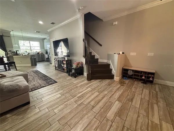 a living room with furniture and a wooden floor