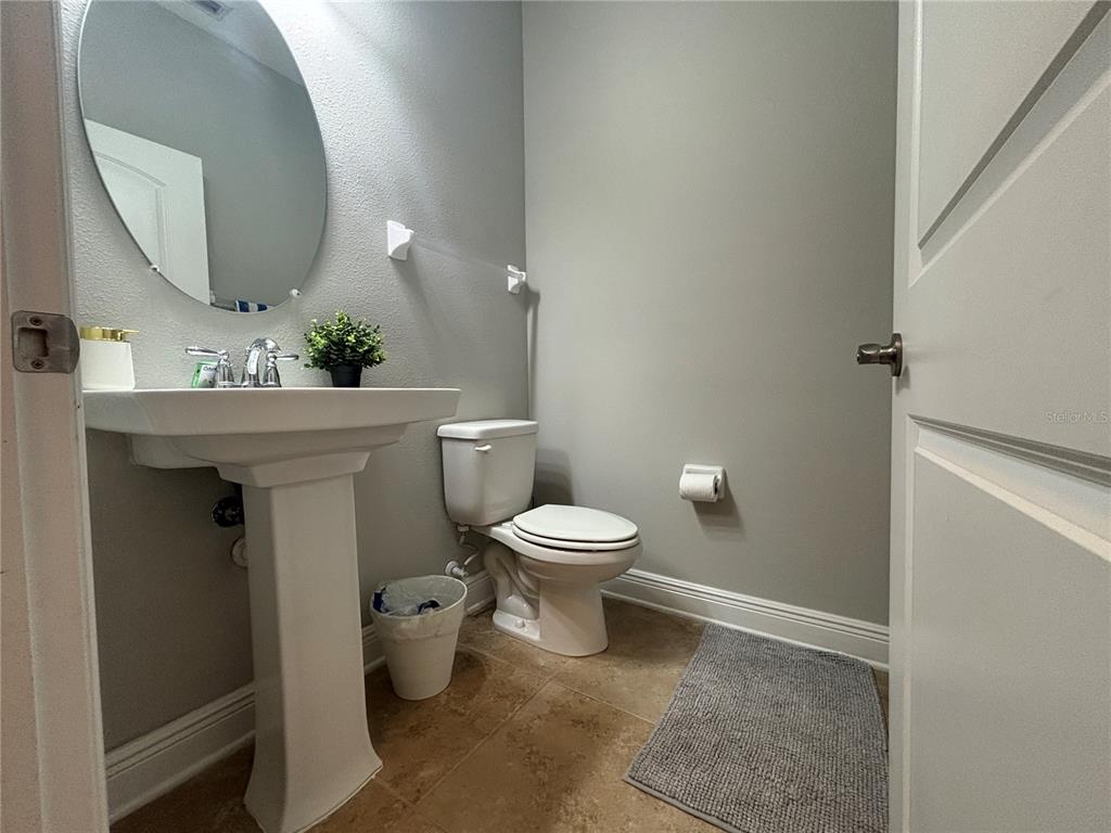 9136 Fox Sparrow Road Tampa, FL 33626 - Photo 9 of 34 a bathroom with a toilet a sink and mirror
