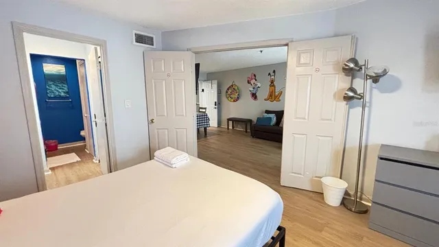 a bedroom with a bed and a mirror