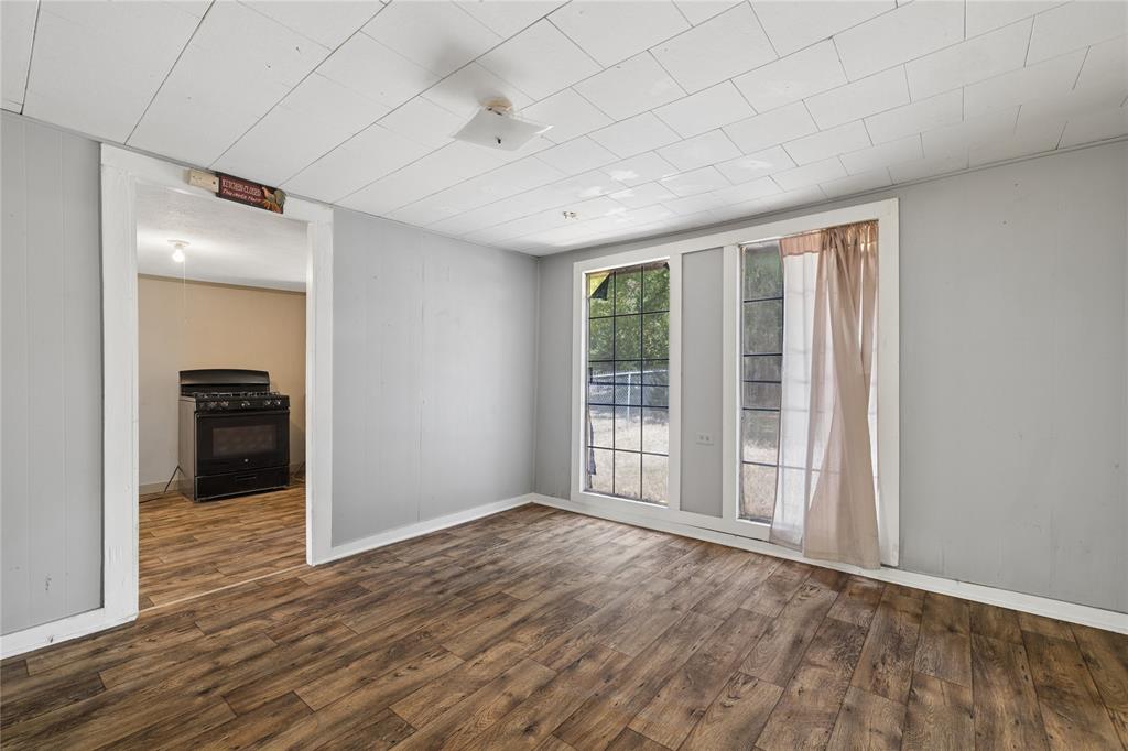 406 Carter Road Malakoff, TX 75148 - Photo 6 of 13 Wood-finish flooring throughout, multiple windows, and a flush mount ceiling light fixture