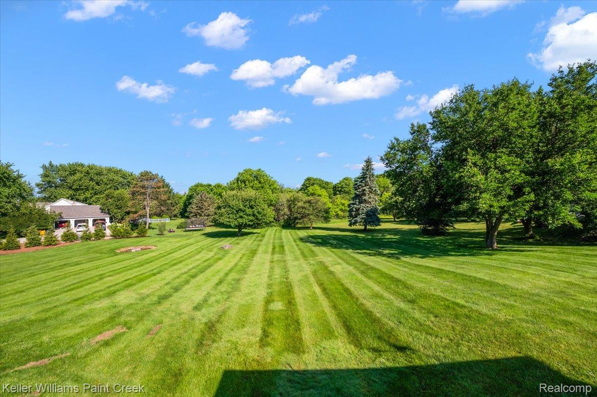69069 Campground Road Romeo, MI 48065 - Photo 17 of 78 Expansive rear lawn with mature trees and a manicured striped pattern