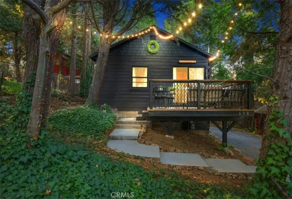 a view of a house with backyard and sitting area