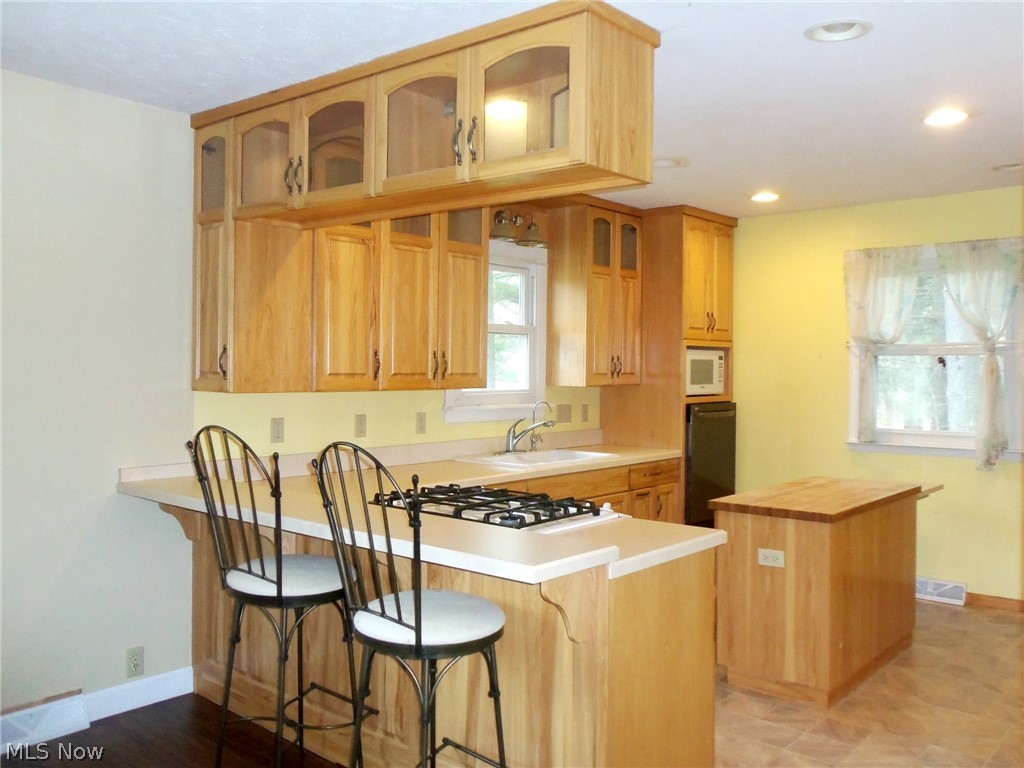 16850 Old State Road Middlefield, OH 44062 - Photo 6 of 23 Kitchen breakfast bar with room for additional stools, island with pop up extension and all the appliances...