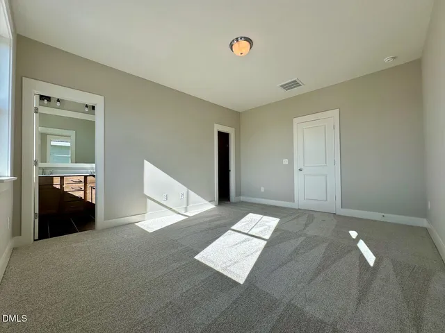 a backyard of a house with lots of plants and wooden fence