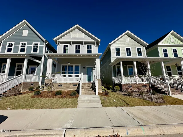 a view of a livingroom with wooden floor and a ceiling fan