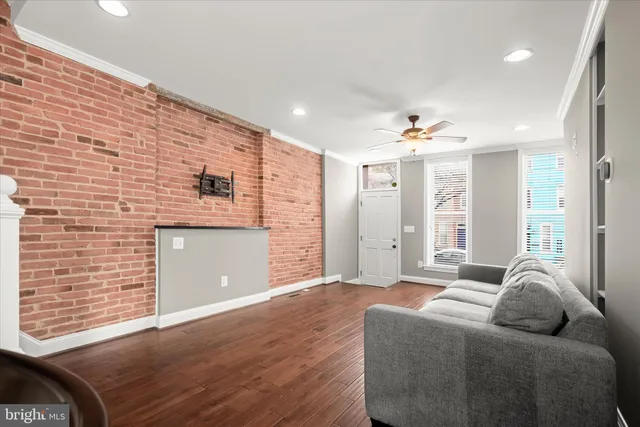 a bathroom with a granite countertop bathtub sink vanity mirror and toilet