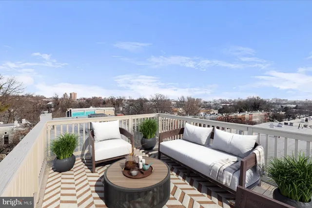 a bedroom with a bed couch and a window