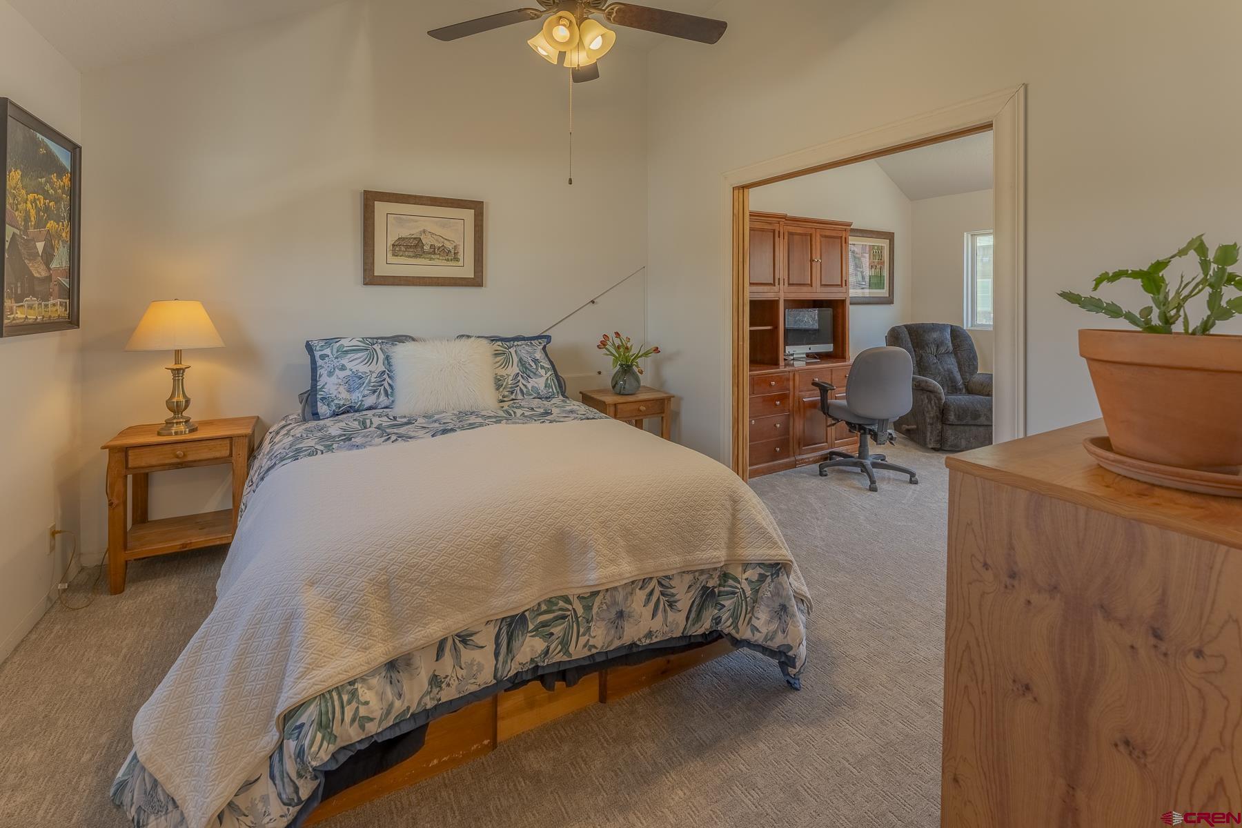 310 2nd Street Crested Butte, CO 81224 - Photo 19 of 42 a spacious bedroom with a bed and a chandelier