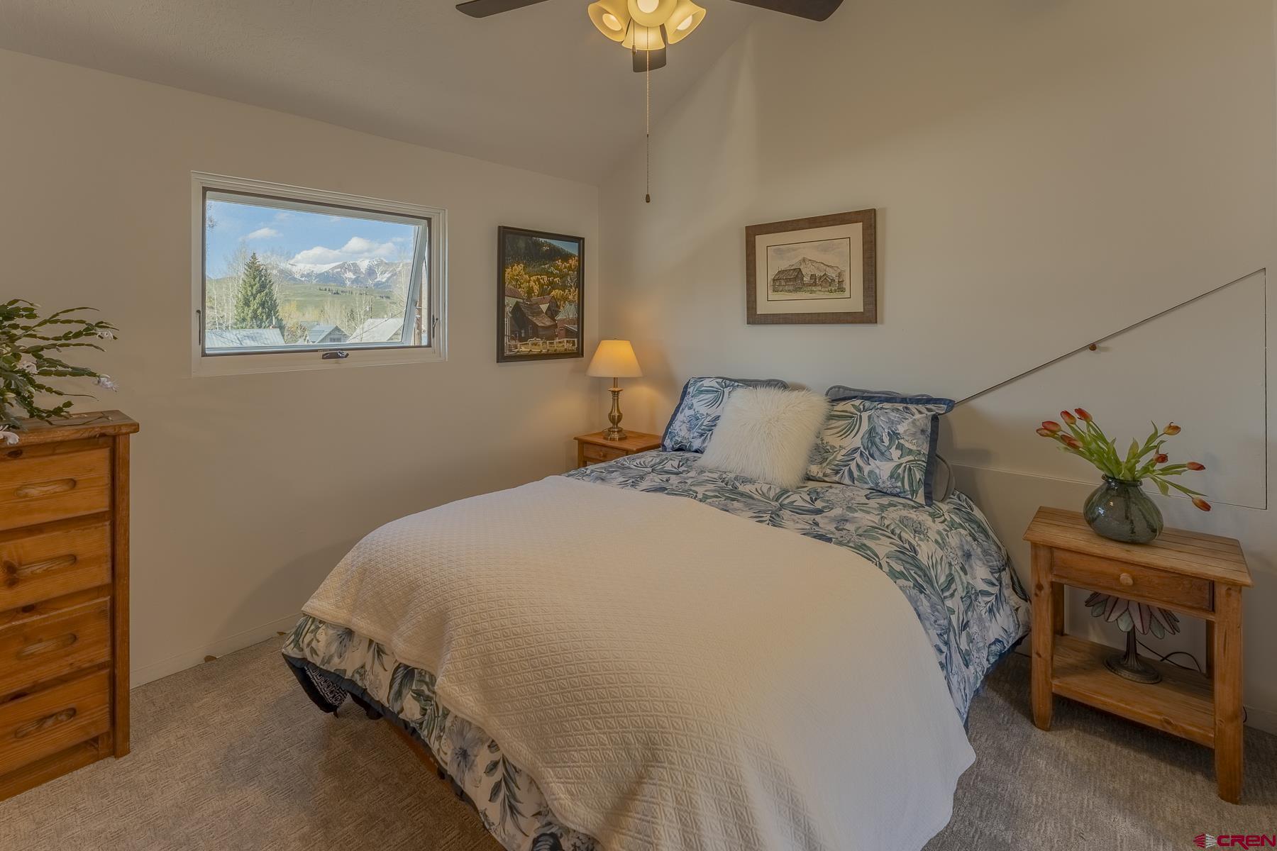 310 2nd Street Crested Butte, CO 81224 - Photo 20 of 42 a bedroom with a bed and a lamp on dresser