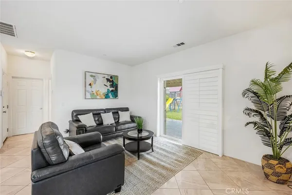 a living room with furniture and a potted plant