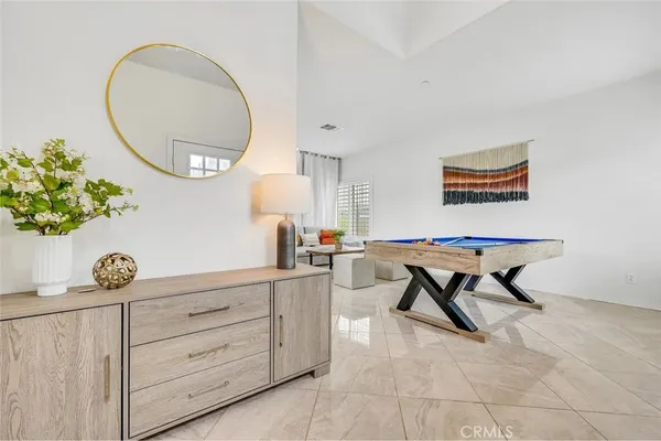 a living room with furniture and a mirror