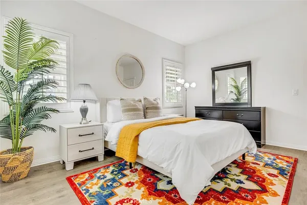 a bed room with a bed and a painting on the wall