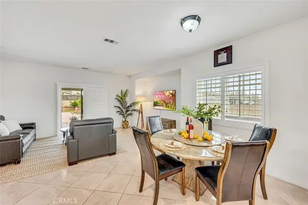 a dining room with furniture and window