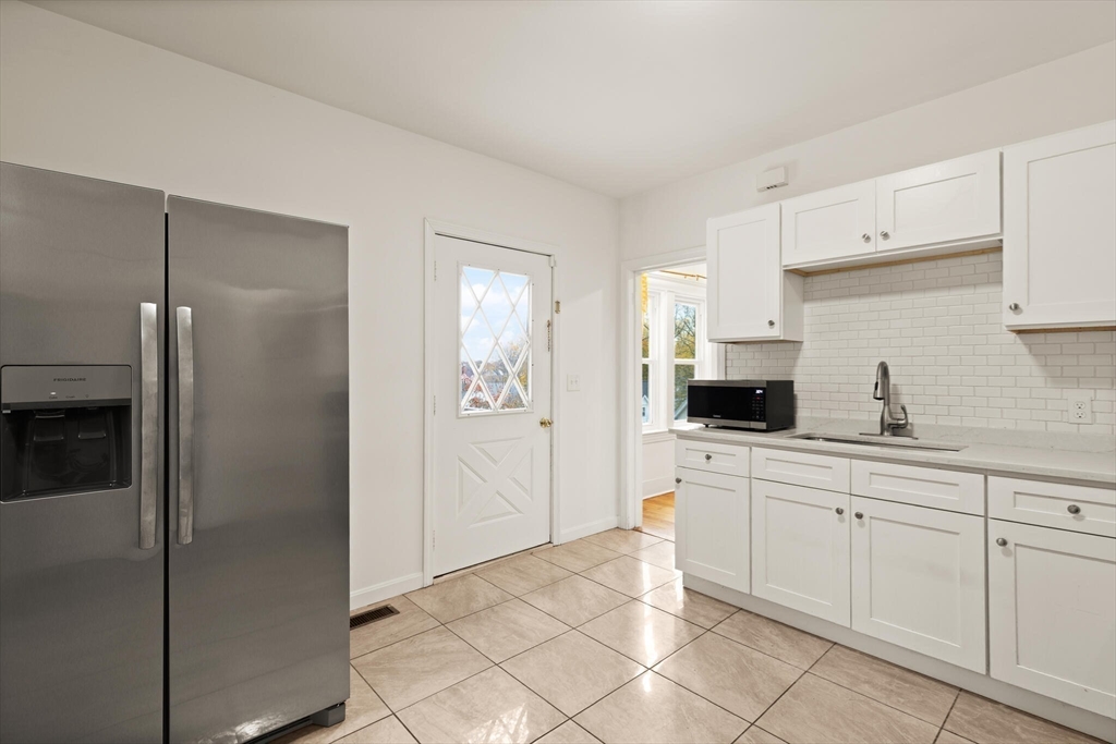 10 Minthorne Street Worcester, MA 01603 - Photo 17 of 29 a kitchen with white cabinets stainless steel appliances and a sink