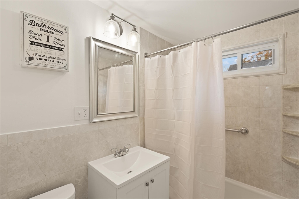 10 Minthorne Street Worcester, MA 01603 - Photo 20 of 29 a bathroom with a shower curtain and a sink