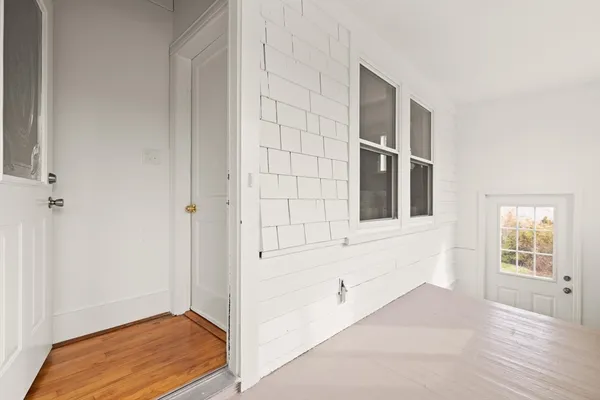 a living room with furniture wooden floor and a window