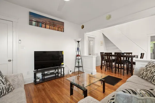 a view of a dining room with furniture and wooden floor