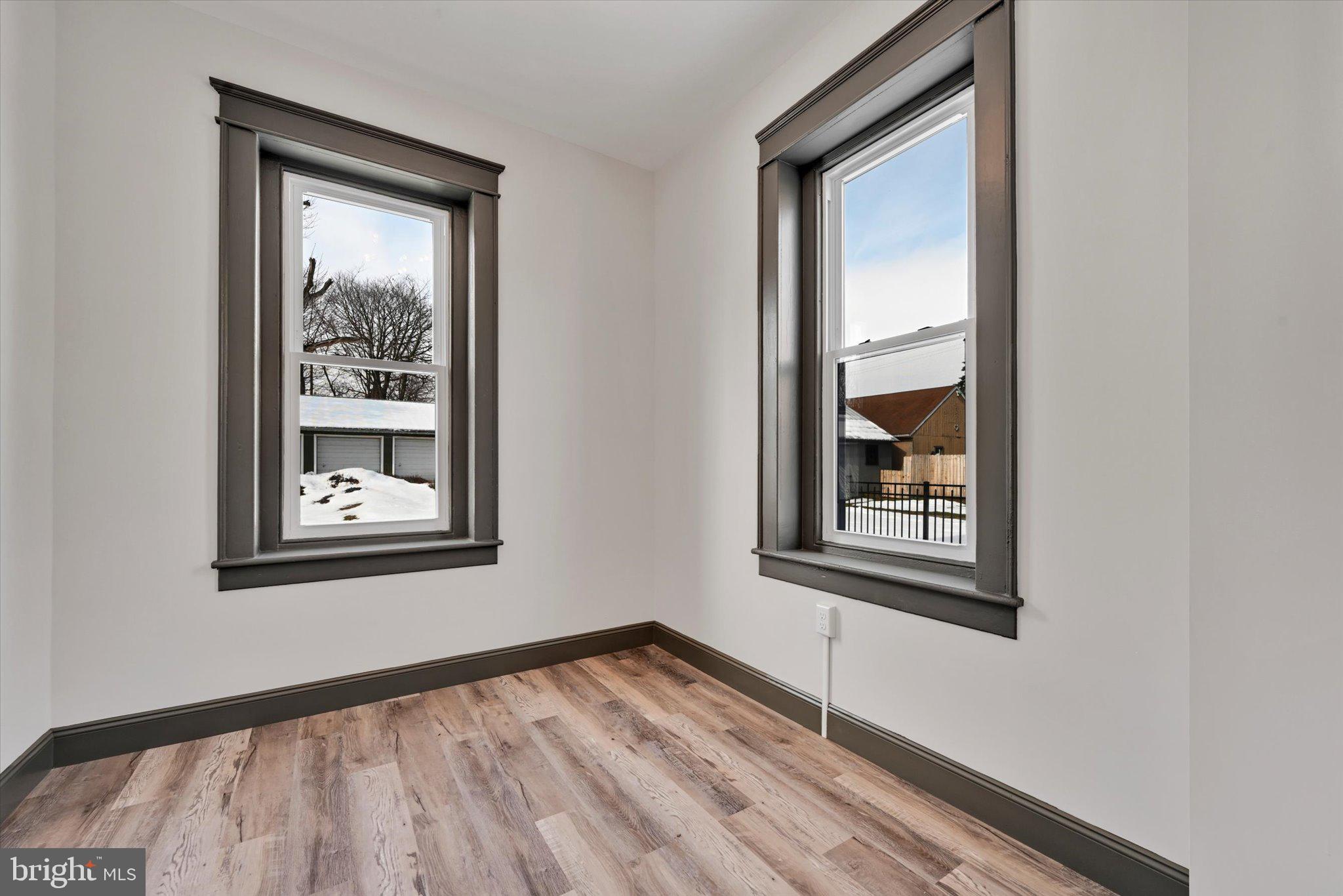 32 North Main Street Topton, PA 19562 - Photo 18 of 36 a view of an empty room with a window and wooden floor