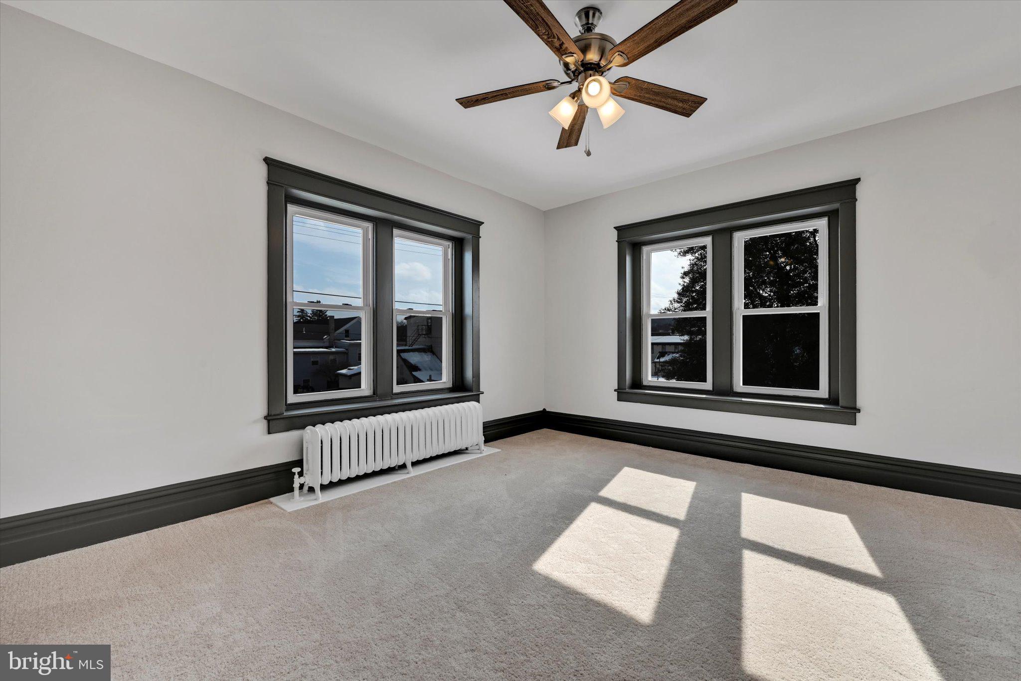 32 North Main Street Topton, PA 19562 - Photo 20 of 36 an empty room with windows and ceiling fan