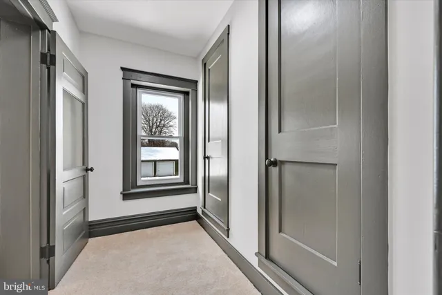 a view of empty room with windows and closet