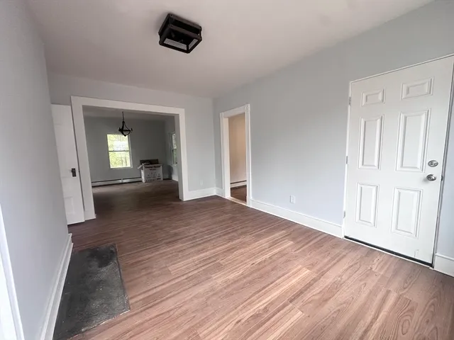 wooden floor in a hall with an entryway of the house