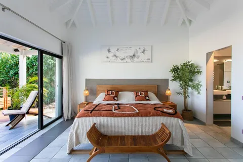 a bed sitting in a bedroom next to a window