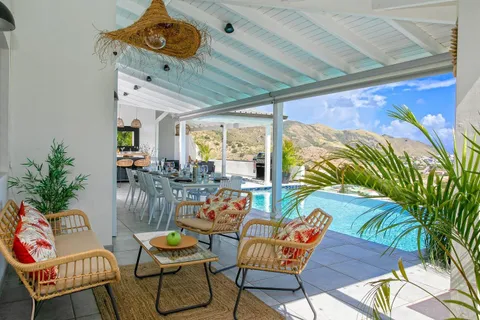 a dining room with furniture and a floor to ceiling window