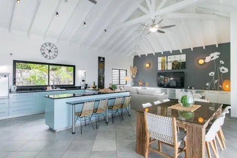 a large kitchen with a table and chairs