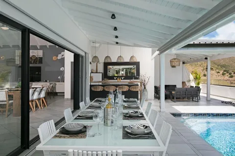 a living room with lots of furniture and a chandelier