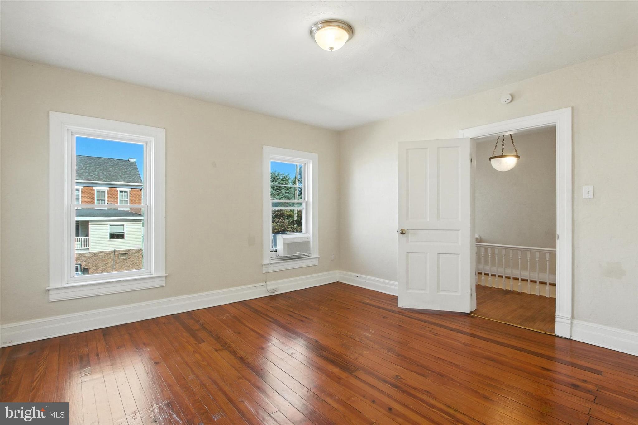 46 North Main Street Spring Grove, PA 17362 - Photo 14 of 25 an empty room with wooden floor and windows