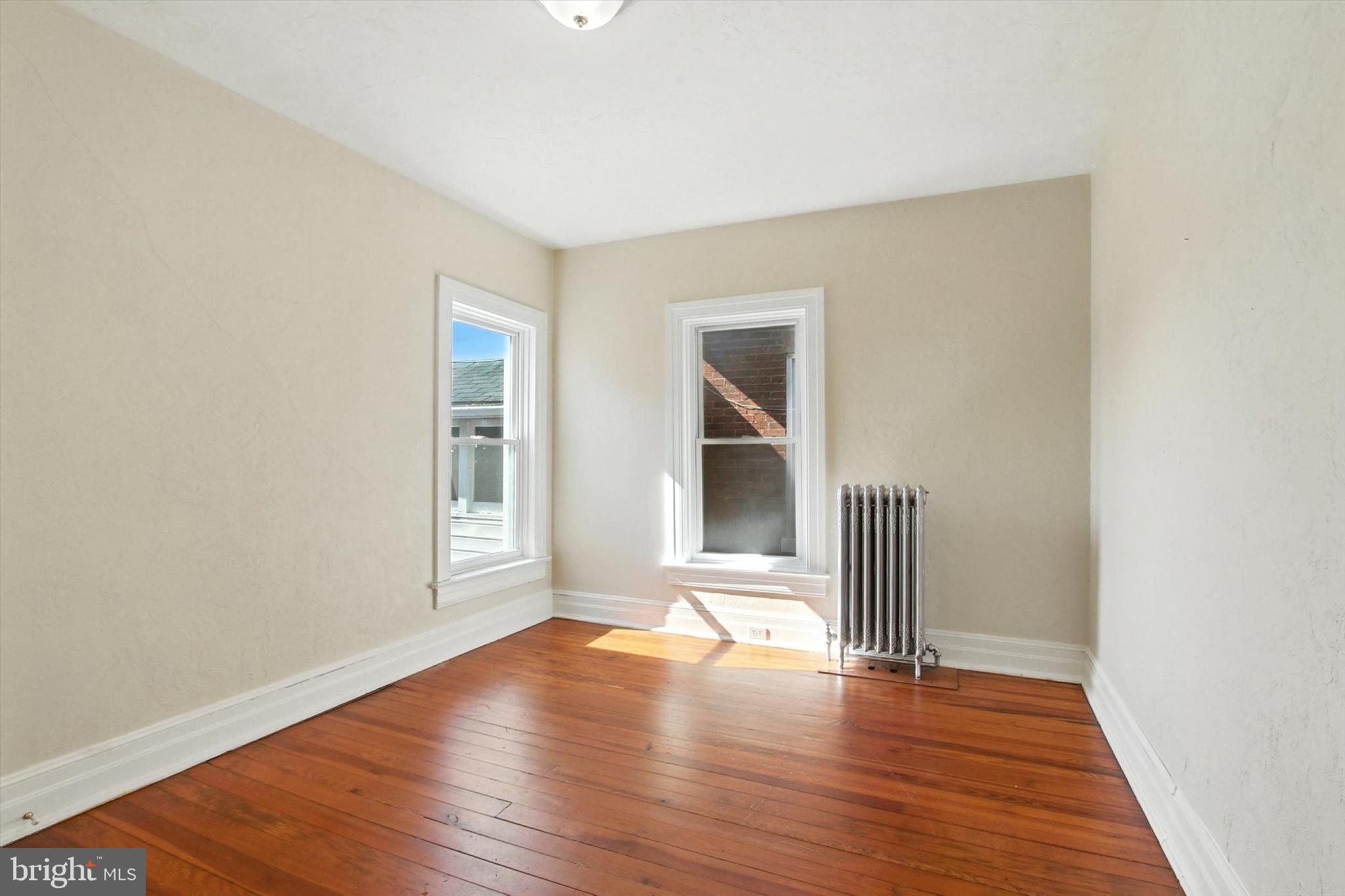 46 North Main Street Spring Grove, PA 17362 - Photo 15 of 25 an empty room with wooden floor and windows