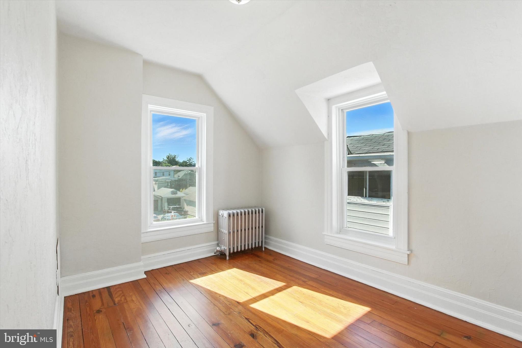 46 North Main Street Spring Grove, PA 17362 - Photo 17 of 25 an empty room with wooden floor and windows