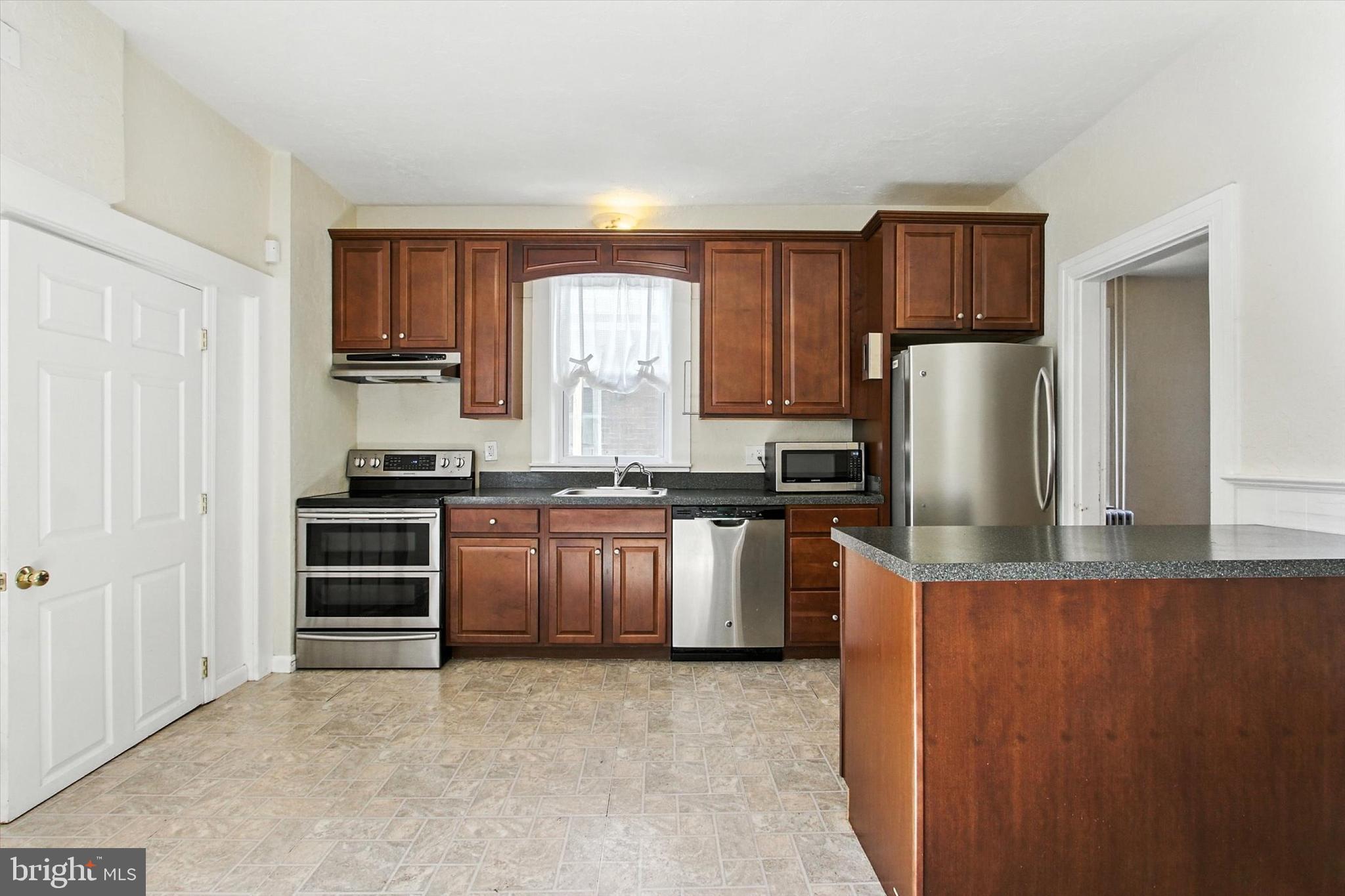 46 North Main Street Spring Grove, PA 17362 - Photo 6 of 25 a kitchen with a refrigerator and a stove top oven