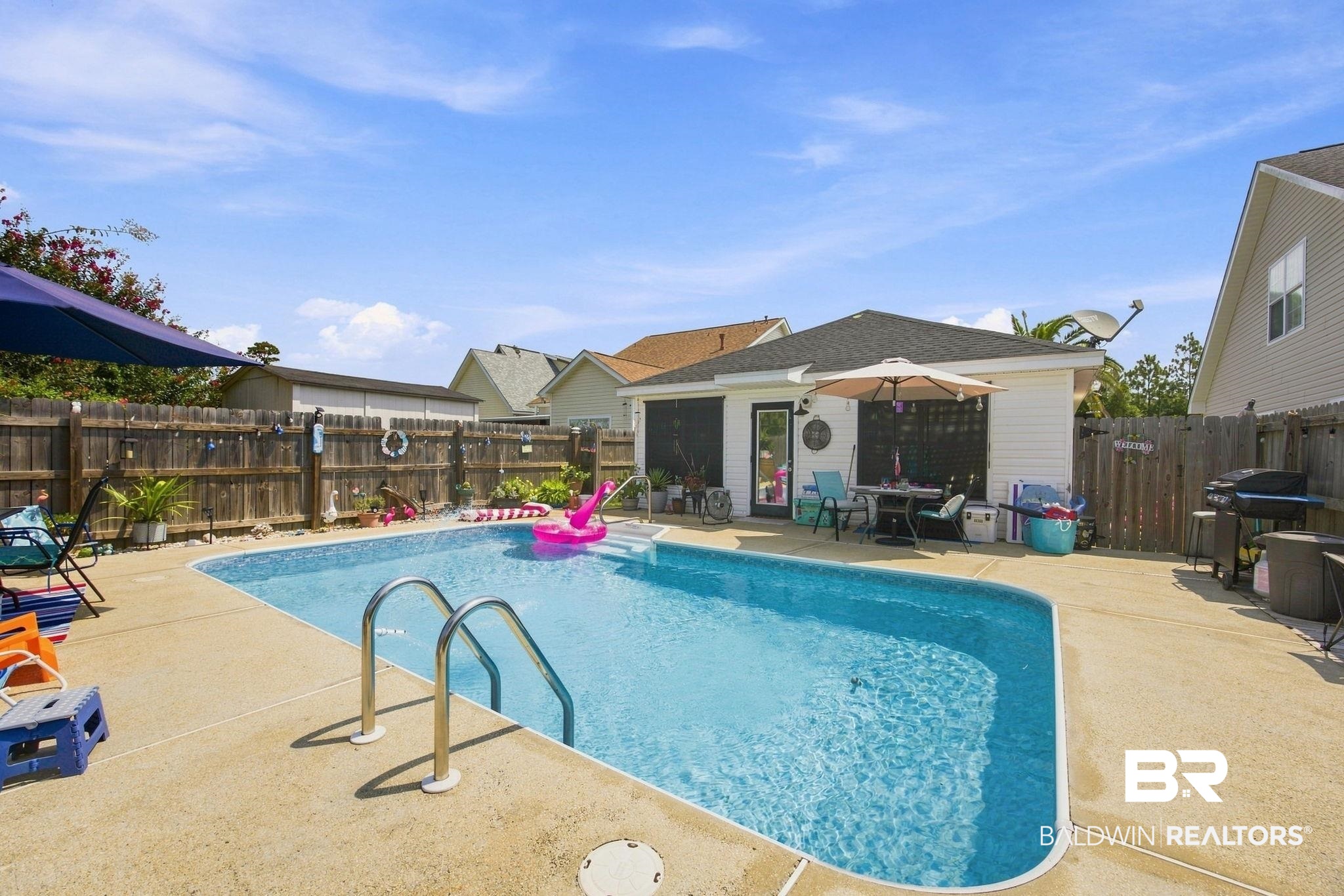 7577 Audubon Drive Foley, AL 36535 - Photo 25 of 33 Expansive backyard featuring a built-in swimming pool with concrete surround
