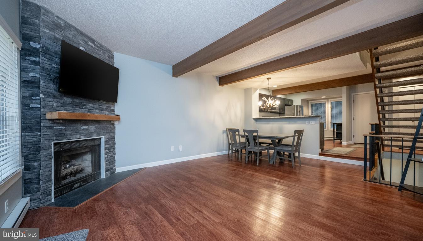 48 Bright Passage, Unit 5B McHenry, MD 21541 - Photo 12 of 56 a living room with furniture a fireplace and a flat screen tv