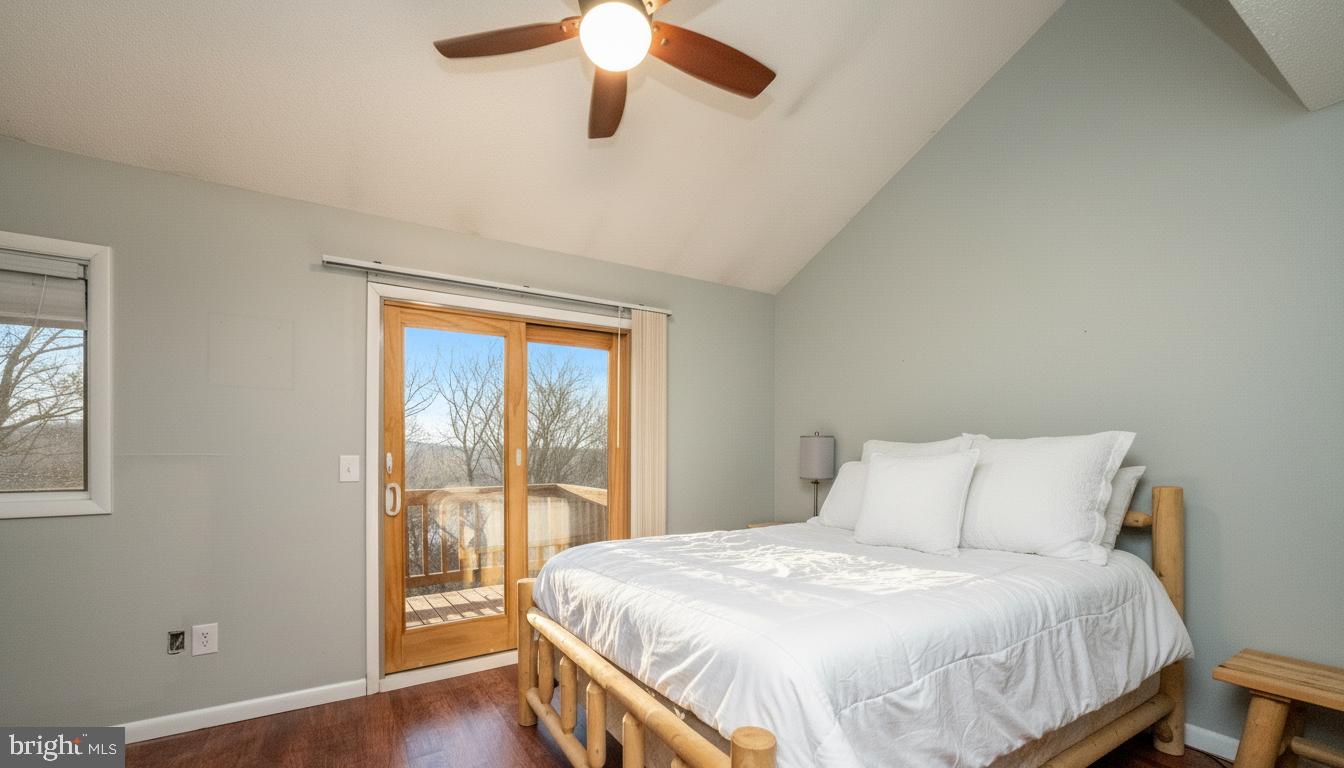 48 Bright Passage, Unit 5B McHenry, MD 21541 - Photo 15 of 56 a bedroom with a large bed and a large window