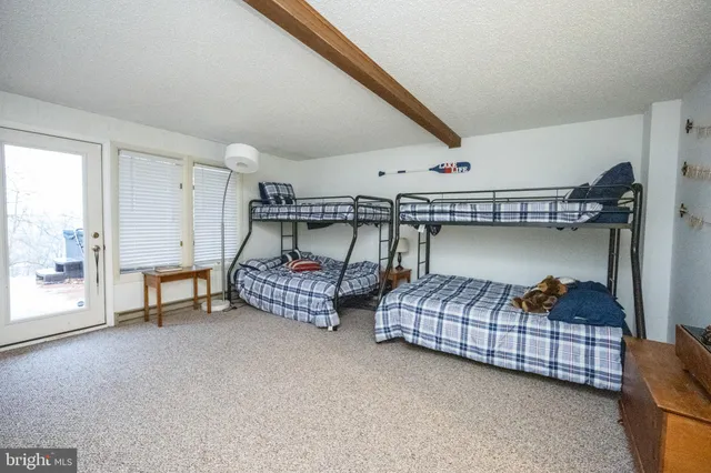 a bedroom with furniture and a window